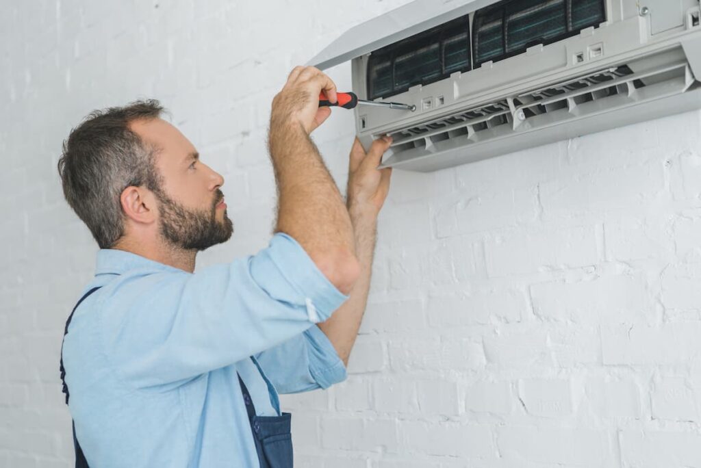 technician repairing ductless air conditioner